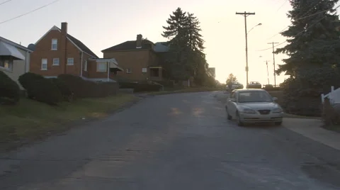 Driving Through Small Urban Town During Sunset Stock Footage 61045962