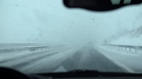 Driving through the snow with activated wipers Stock Footage 36480127