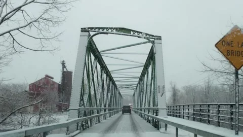 Driving through the snow over bridge Video stock 327673387