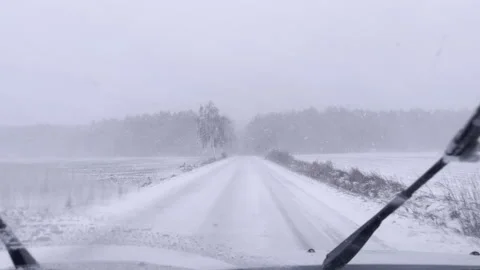 Driving through snow storm or blizzard. Winter POV from car. Stock Footage 325888158