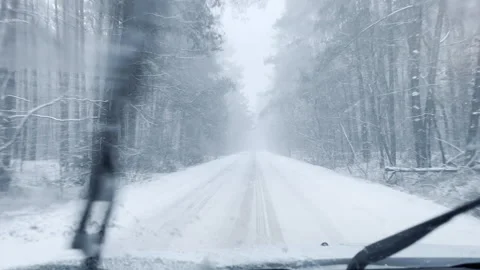 Driving through snow storm or blizzard. Winter POV from car. Stock Footage 325888387