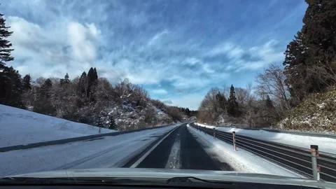 Driving through snowy forest highway crossing bridge no traffic Video stock 333091243