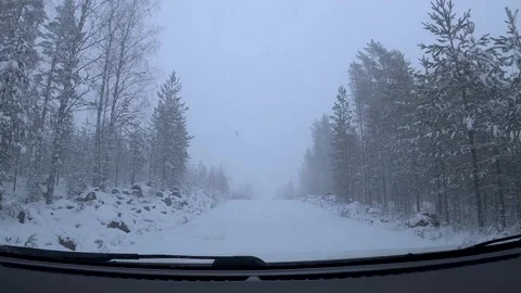 Driving Through Snowy Forest Road During Heavy Spring Snowfall in Finland Stock Footage 333768700