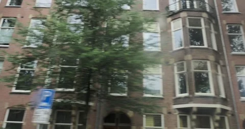 Driving through the streets of Amsterdam, showcasing iconic architecture and Stock Footage 300617466