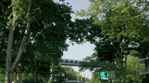Driving through tree-lined street Sheepshead Bay toward Verrazano Bridge 4K NYC 库存影片 52077128