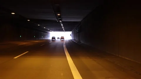 Driving through tunnel toward bright exit light Stock-Footage 331179923