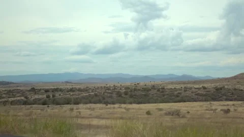 Driving through a vast desert landscape in Arizona with mountains in the di.. Stock Footage 280204878
