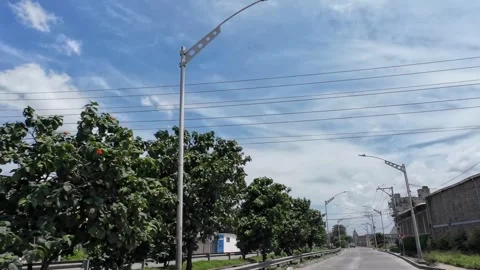 Driving Through Village with Roadside Trees and Poles 库存影片 341368999