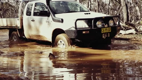 Driving through water and mud in a 4wd Video stock 82519540
