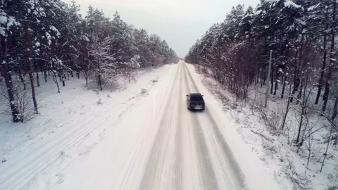 Driving Through the Winter Forest - Snow Drifts on the Road Stock Footage 220809341