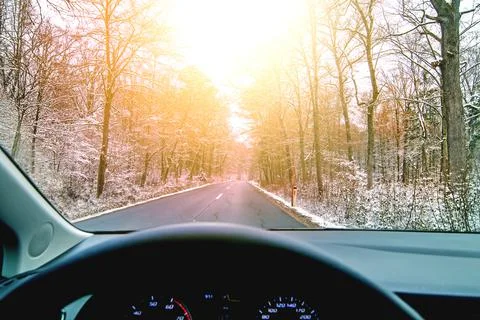 Driving through winter forest at sunset Foto stock