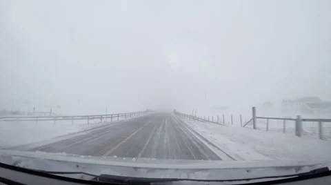 Driving through winter scenery high mountain snow wind pov Stock Footage