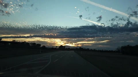 Driving Toward Dramatic Sunset on Empty Country Roac Vidéo 344312004