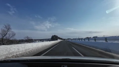 Driving toward expressway exit ramp and toll gate on snowy highway in Hokkaido Stock Footage 333229839