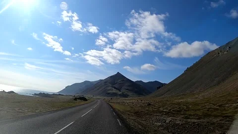Driving toward steep mountain peaks on the Icelandic coast Stock Footage 333974778
