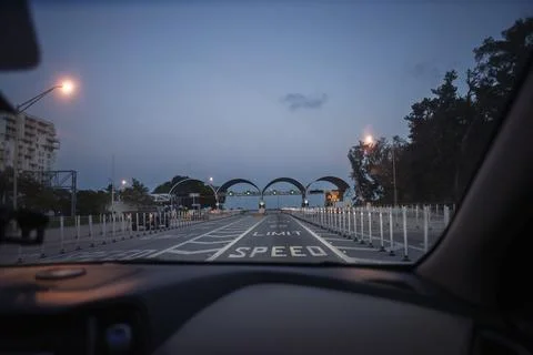 Driving towards a security checkpoint at dawn Stock Photos