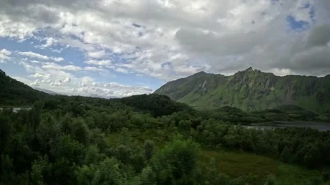 Driving tracking shot of panoramic mountain lake and green peaks in Norway Stock-Footage 343833885