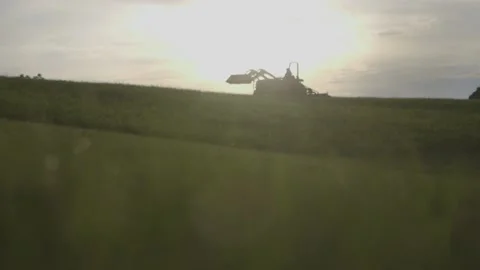 Driving a tractor during sunset Stock Footage 201677845