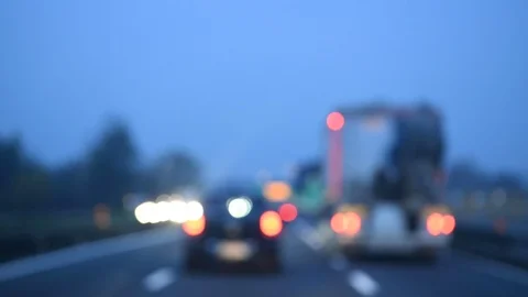 Driving in traffic. Intentionally blurred lights in the city highway at night. Video stock 98780486