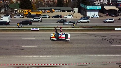 Driving on two wheels with two guys on top of the hood Stock Footage 91557257