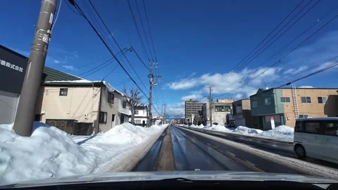 Driving under bridge on wet winter road in Hakodate city street Video stock 333069401