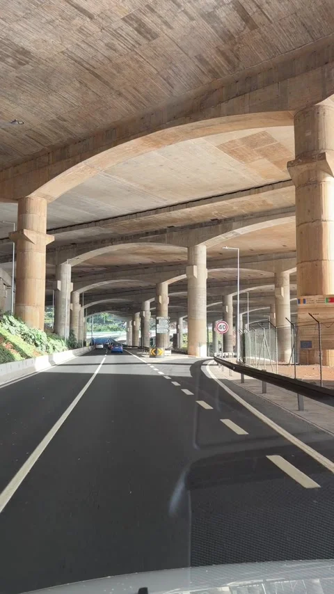 Driving under the famous runway bridge of Madeira Airport  Video stock 331252142