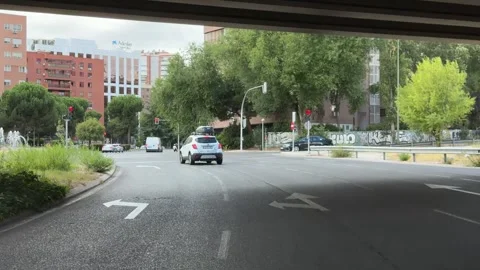 Driving under a highway overpass in Madrid, Spain Видео 344583056