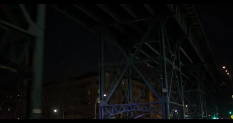 DRIVING UNDER THE L TRAIN LINE AT NIGHT - NYC Stock Footage 141523312
