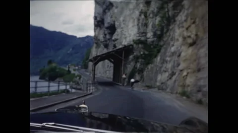 Driving Under Wooden Structure Along Lake in Switzerland 1957 Stock Footage 48078010