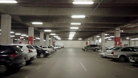 Driving in underground garage or modern car parking with lots of vehicles Stock Footage 167561989