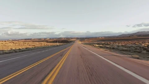 Driving USA: Beautiful point of view shot on long straight road, sunrise/sunset Stock Footage