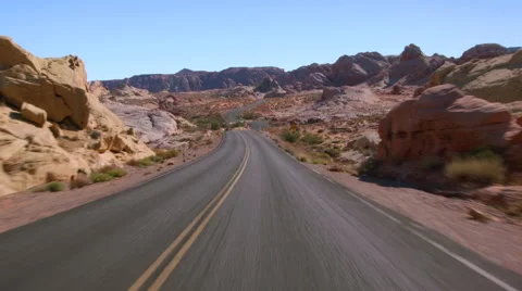 Driving USA: Car POV along an empty desert road through the Valley of Fire, USA Stock Footage
