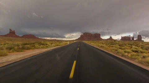 Driving USA: Point of view driving on a lonely road, Monument Valley, Arizona Stock Footage 56965533