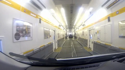 Driving a van through the Eurotunnel train carriage towards exit Stock Footage 112384347