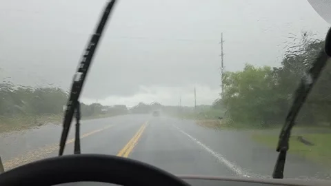 Driving a vehicle down the highway in a hard rainstorm with the windshield Stock Footage 336468409