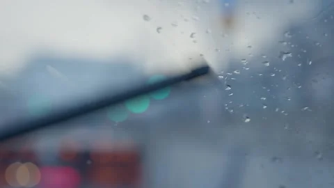 Driving vehicle during winter - close up on windshield with raindrops and wiper Stock Footage 293705791