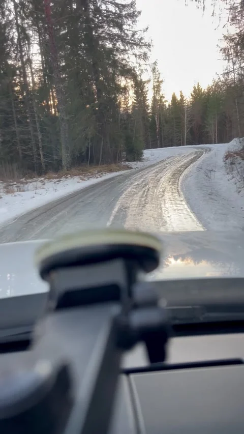 Driving view of an extremely ice covered forest road in mid-winter forest Stock Footage 297674684