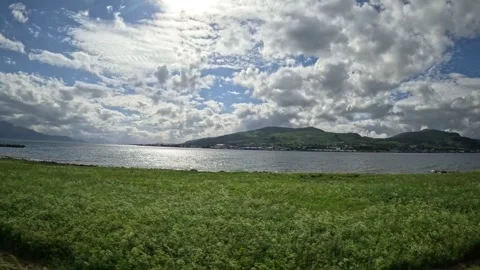 Driving view past small creek flowing into scenic fjord in Norway Stock-Footage 343380294