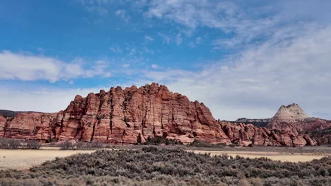 Driving view of sagebrush moving by looking in the Zion wilderness Stock Footage 329149290