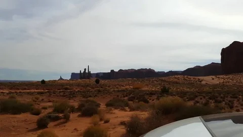 Driving view on a sand road and red mountains at a red desert, at monument .. Stock Footage 72393183