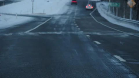 Driving view of snow blowing on street in slow motion snowstorm Stock Footage 171908706