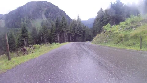 Driving on a wet mountain road on the austrian sölkpass Stock Footage 137494950
