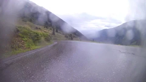 Driving on a wet mountain road on the austrian sölkpass Stock Footage 137495189
