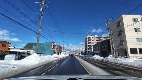 Driving on wet road with distant mountain in Hakodate winter city Video stock 333069446