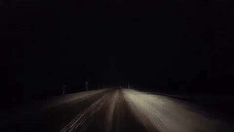 Driving While Snowing on Rural Road at Night.  Driver Point of View Stock Footage 125494523