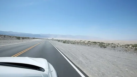 Driving in a white SUV on a road through the desert Stock Footage 85460146