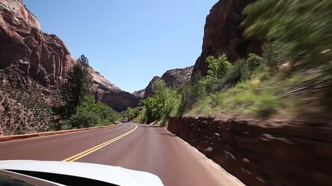 Driving in a white SUV on a road through a canyon Stock Footage 85460163