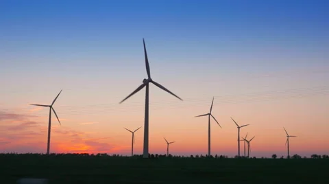 Driving by the Wind Farm and Power Lines in the Evening Stock Footage 64848509