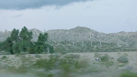Driving by windmills in the desert Video stock 106469696
