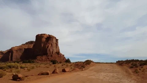Driving window view on a sand road and red mountains at a red desert, at mo.. Stock Footage 72394976